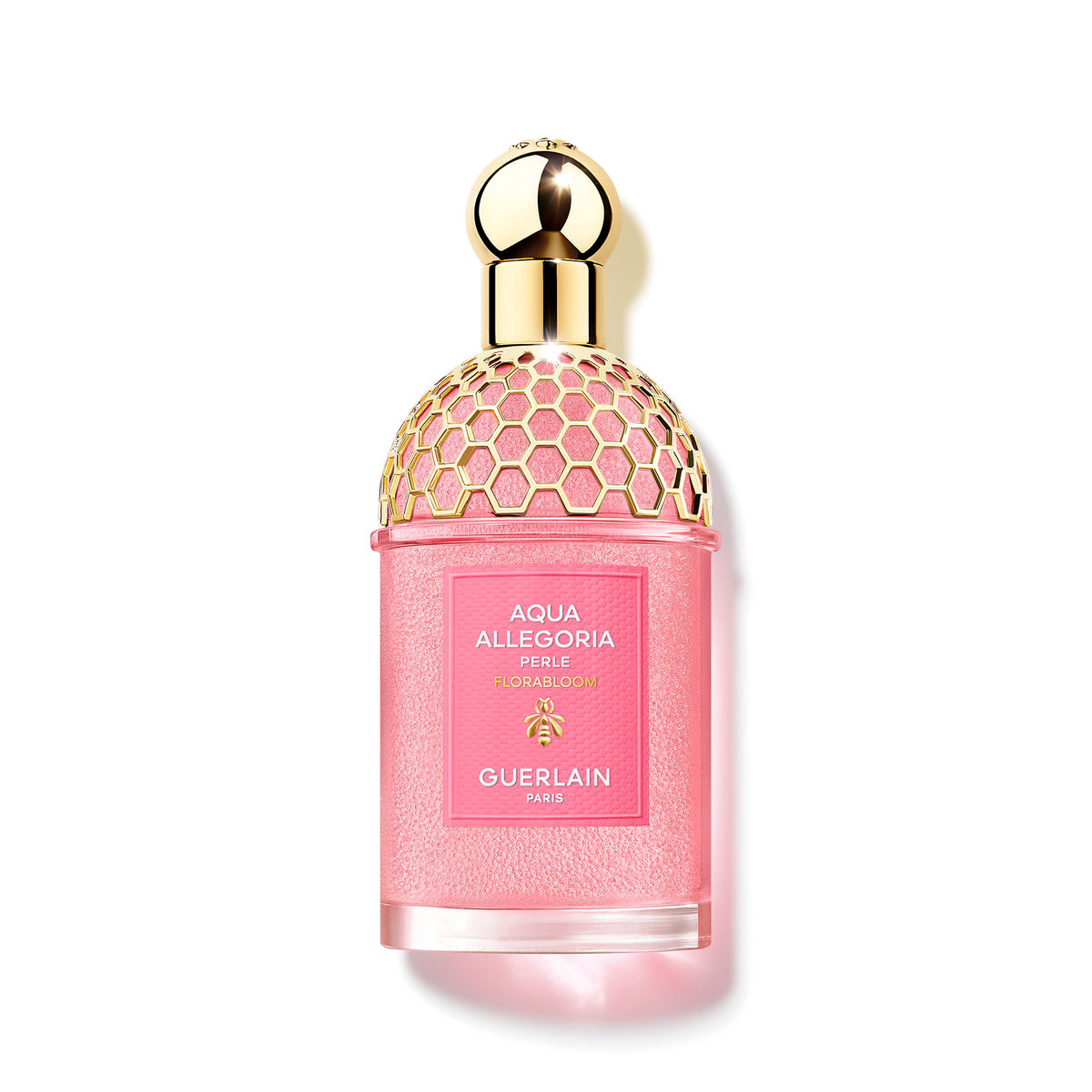 Guerlain Aqua Allegoria Florabloom Perle bottle with pink fragrance pearls, a golden honeycomb pattern and a spherical cap, isolated from the background.