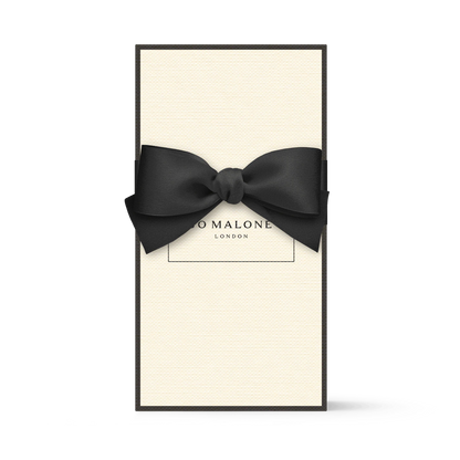 Cream-coloured Jo Malone London gift box with a black bow.