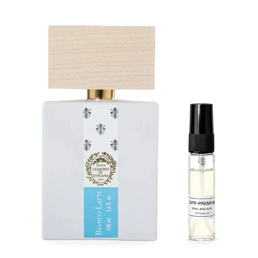 Giardini di Toscana Bianco Latte: Originalflakon neben einer DFP Parfumprobe im Glaszerstäuber mit schwarzer Kappe auf weissem Hintergrund.