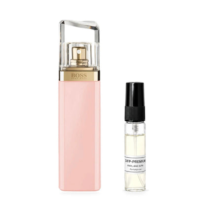 Hugo Boss Femme: Originalflakon neben einer DFP Parfumprobe im Glaszerstäuber mit schwarzer Kappe auf weissem Hintergrund.