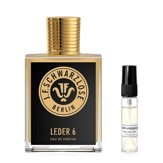 J.F. SCHWARZLOSE Leder 6: Originalflakon neben einer DFP Parfumprobe im Glaszerstäuber mit schwarzer Kappe auf weissem Hintergrund.
