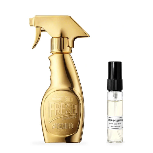 Moschino Gold Fresh Couture: Originalflakon neben einer DFP Parfumprobe im Glaszerstäuber mit schwarzer Kappe auf weissem Hintergrund.