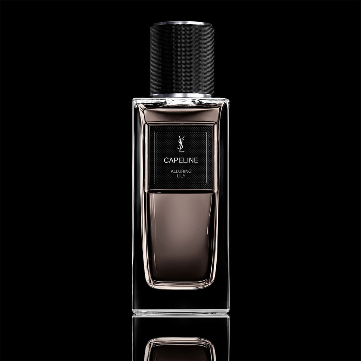 Yves Saint Laurent Capeline Alluring Lily Eau de Parfum in a rectangular glass bottle with a black cap against a black background.