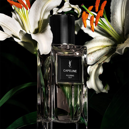 Yves Saint Laurent Capeline Alluring Lily Eau de Parfum bottle among white lilies and green leaves.